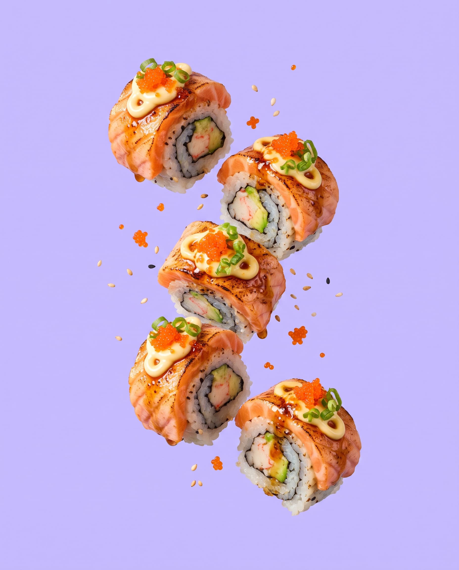 Torched salmon aburi roll pieces with yuzu mayo and tobiko on lavender