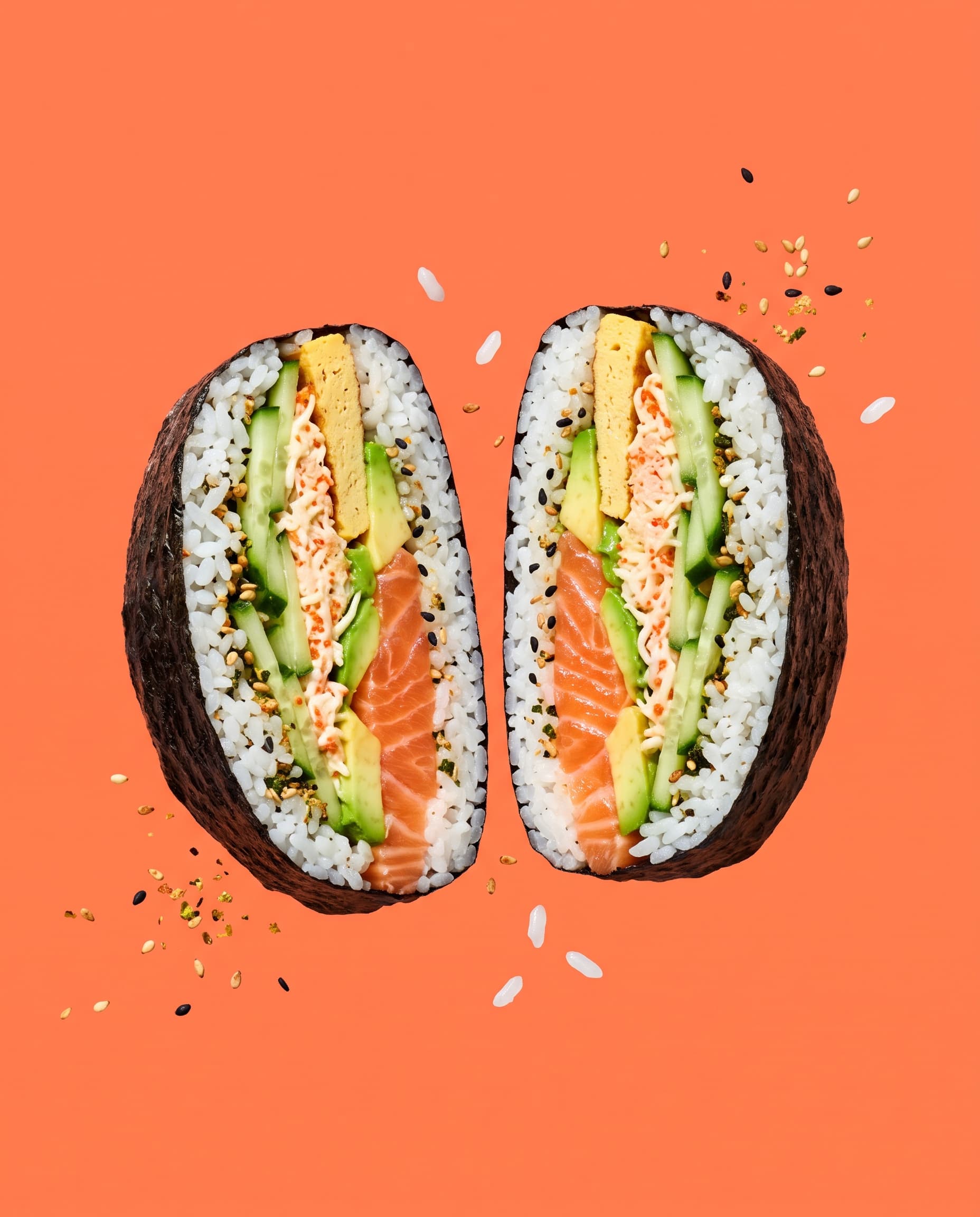 A sushi sandwich cut in half showing salmon, avocado and crab layers on coral