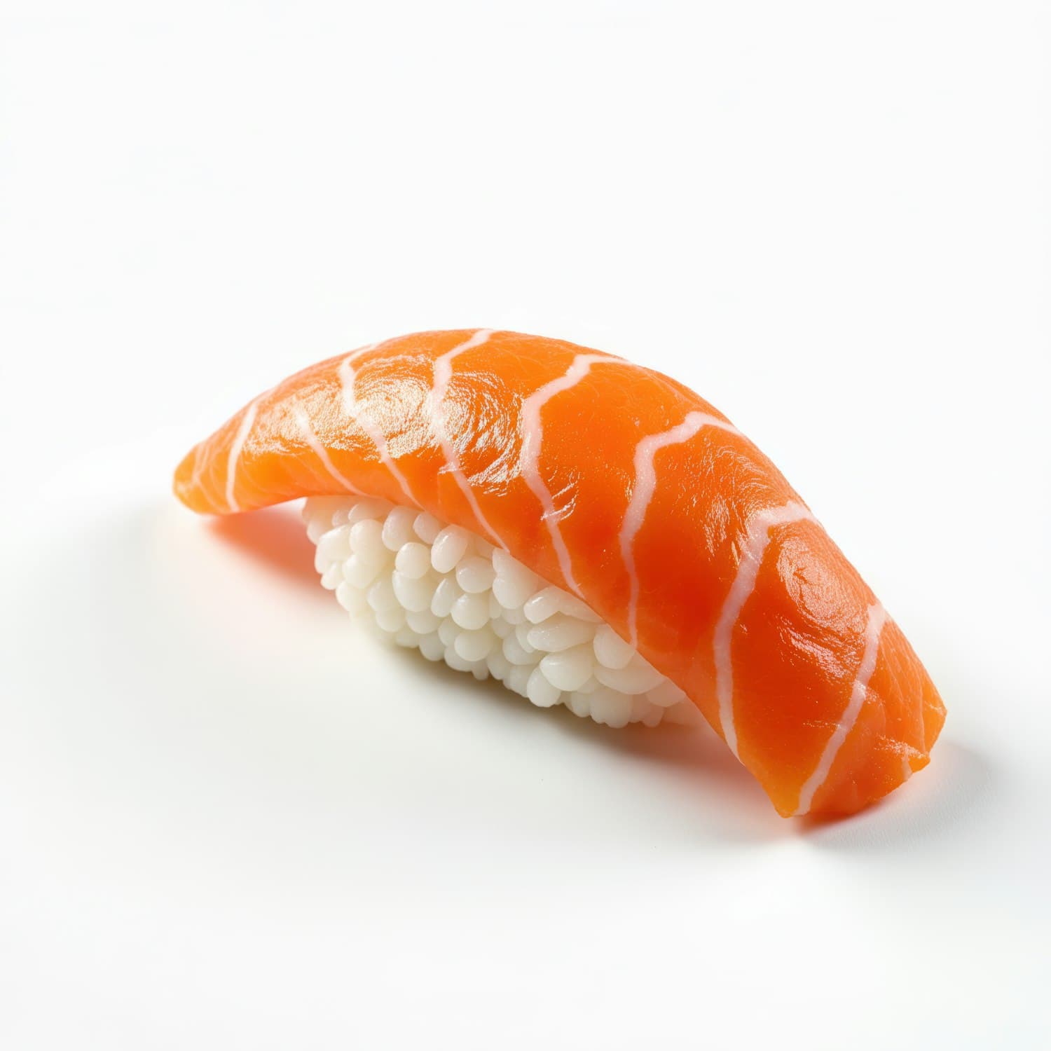 A single piece of salmon nigiri over hand-pressed rice